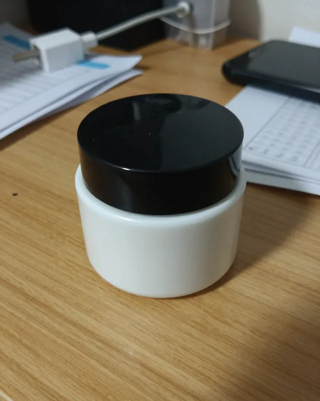 The original phone photo of Olea's product, shot casually on a messy surface